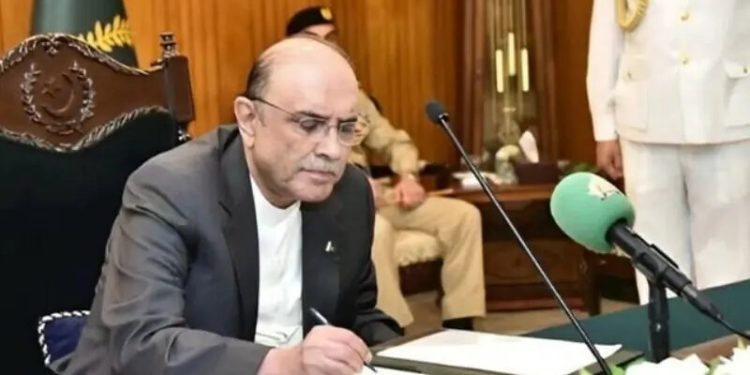 President Asif Ali Zardari gave his assent to the contentious 27th Constitutional Amendment on Thursday, enacting it into law.

The summary signed by the president, a copy of which is available with Dawn, states: “The Constitution (Twenty-Seventh Amendment) Bill, 2025, is assented to, as advised by the prime minister, at para 5 of the summary.”


Meanwhile, sources told Dawn that the president was expected to administer the oath to the chief justice of the Federal Constitutional Court — the establishment of which would now be realised after the enactment of the 27th Amendment bill — tomorrow at the Presidency.

Senate’s approval
The president’s assent to the legislation came hours after the Senate approved the bill for the amendment after voting on it for a second time amid the opposition’s protest.

Announcing the result, Senate Chairman Yousuf Raza Gilani said 64 votes had been cast in favour of the bill and four against it. “So the motion is carried by the votes of not less than two-thirds of the total membership of the Senate, and consequently, the bill stands passed.”

The house first voted on the bill clause by clause and then by division. While clause-by-clause voting was under way, slogans of aain ki tabahi, na manzoor (destruction of the Constitution, unacceptable) filled the house, prompting Gilani to say at one point, “No slogans”.

The bill was initially presented in the Senate for voting on Monday and passed the same day. It was then referred to the NA, which approved it with some amendments yesterday. Therefore, the proposed legislation was again presented in the Senate today to consider the latest changes.

Law Minister Azam Nazeer Tarar again tabled the bill in the upper house of Parliament today.

Elaborating on the changes and the bill’s salient features, he said the incumbent chief justice of Pakistan (CJP) would continue to hold this post until he held the office. Following his retirement, he said, the senior one among the top-most judges of the Supreme Court and the planned Federal Constitutional Court would have the title of the CJP.

He added that according to the proposed amendment, the CJP would administer the oath to the president, chief election commissioner and auditor general for Pakistan.

Detailing changes to Article 6 of the Constitution, which deals with the subject of treason, he said the provision would now read: “Any court in Pakistan, be it the Federal Constitutional Court that will now, God willing, be established, the Supreme Court or high courts, cannot validate the abrogation of [of the Constitution].”

This was akin to blocking martial laws and upholding democracy, he argued.

Speaking against the proposed amendment, PTI Senator Ali Zafar criticised the government for its “haste”.

“They want to establish their constitutional court at the earliest so that they can control it. And the reason behind the haste is the fear of one person, who is in jail a few miles away from here,” Zafar alleged.

He further stated that the 27th Amendment was based on “deceit and fraud”, asserting that the proposed legislation did not have the people’s support. “The very foundation of the 27th Amendment is based on fraud and deception, and this building is going to fall,” he warned.

The matter of defection
Immediately after Tarar tabled the bill in the Senate, Senator Zafar had highlighted that the house would be voting for the second time on the constitutional amendment. The amendment, he said, would need the support of a two-thirds majority in the Senate, which meant at least 64 votes.

He recalled that during the first instance of voting, PTI’s Saifullah Abro and another senator from the Jamiat Ulema-i-Islam (Fazl) had voted in favour of the amendment and against the party line.

After casting his vote, Abro had announced his resignation on the floor of the house.

Senate Chairman Yousuf Raza Gilani was asked about it while he was speaking to the media at Parliament today morning. In his response, Gilani said after formally receiving Abro’s resignation in writing, he would call him and maybe, “I am able to convince him”.

Later, PTI’s Zafar pointed out to him in the Senate that the defection by Abro led to the application of Article 63-A, which stipulated that Abro stood disqualified. Moreover, he said, Abro had also announced his resignation.

In light of these developments, he requested that the votes of the defecting senator not be counted.

“Otherwise, we will have to challenge this entire process,” he said.